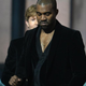 Beck (background), winner of the Grammy for Album of the Year, reacts as Kanye West leaves the stage during the 57th annual Grammy Awards in Los Angeles Feb. 8, 2015.
ROBYN BECK/AFP/Getty Images